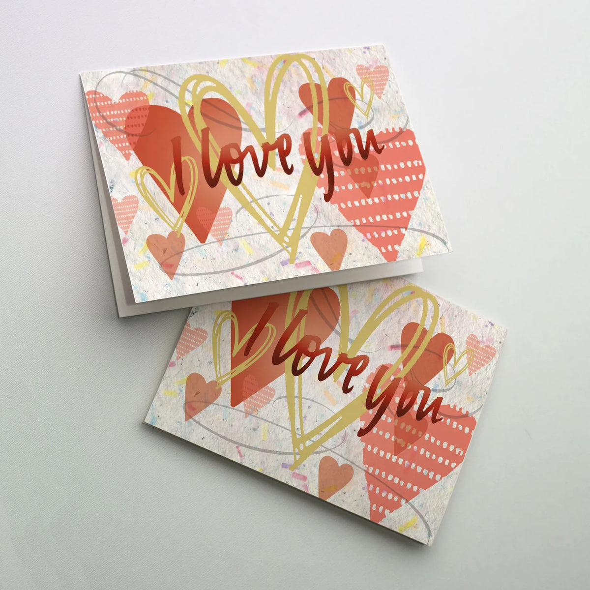 St. Valentine's Day greeting card with layered heart designs and handwritten-style "love you" text on textured background