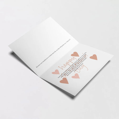 Open St. Valentine's Day greeting card with printed loving message and heart illustrations on white background