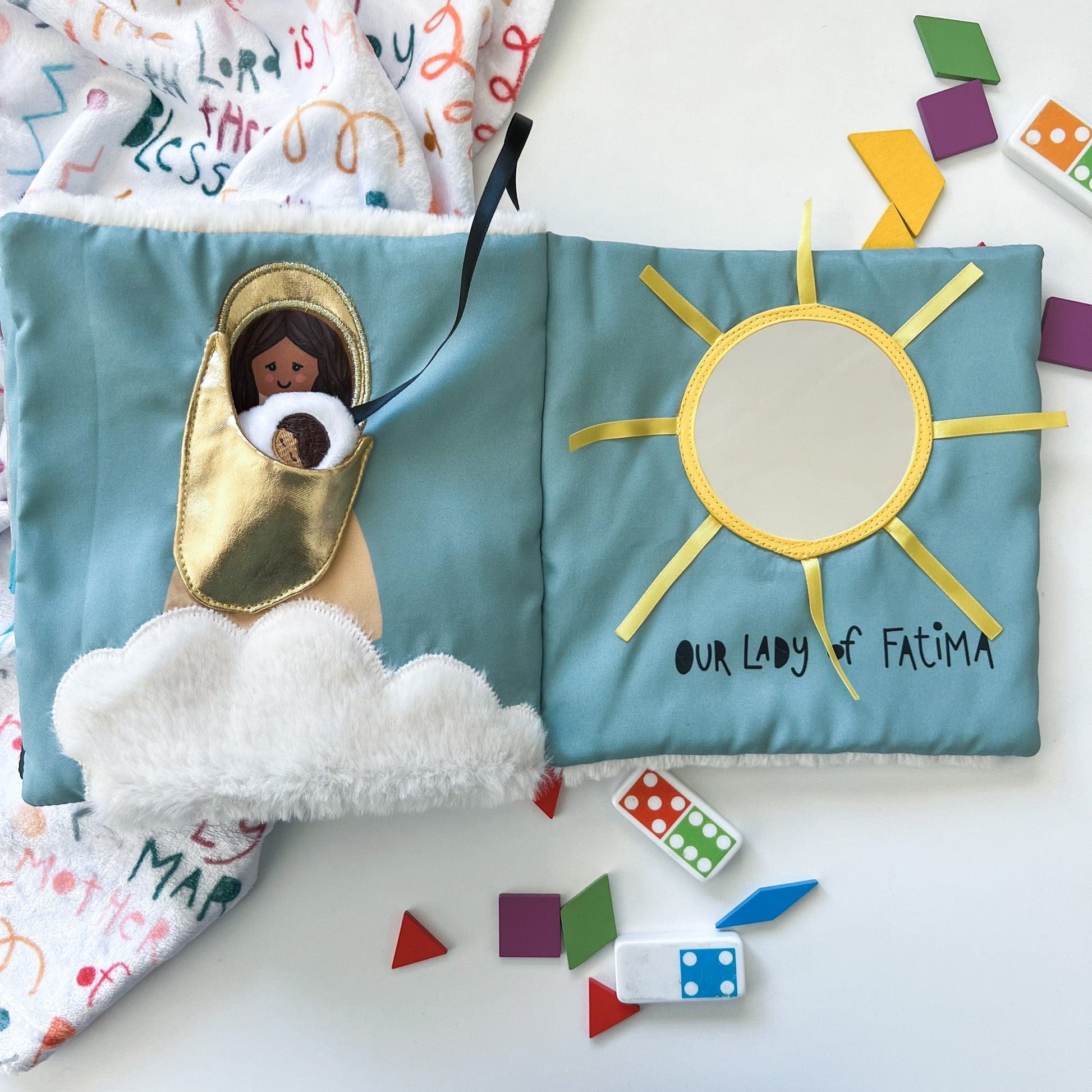 Soft fabric religious quiet book page with Mary holding baby Jesus and sun with Our Lady of Fatima text