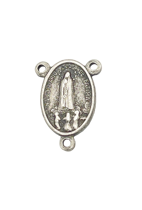 An oval silver-toned metal religious charm featuring a depiction of the Virgin Mary with three small loops at the top and bottom, shown on a plain white background.
