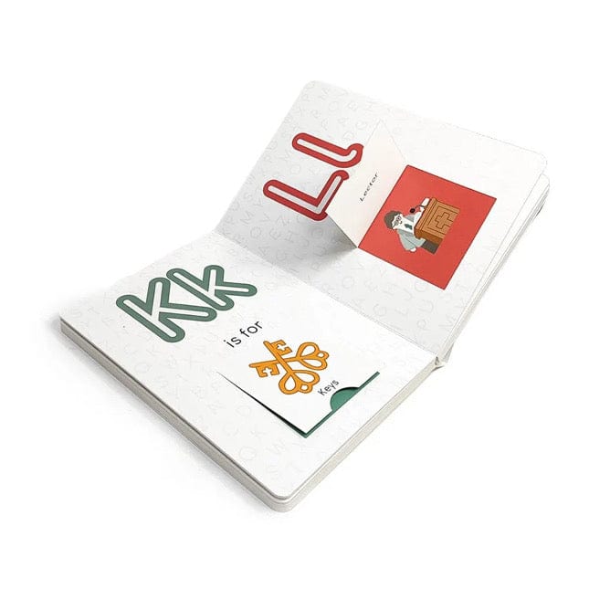 Open pages of Catholic ABC Board Book showing letters K and L with illustrated religious-themed cards inside pockets