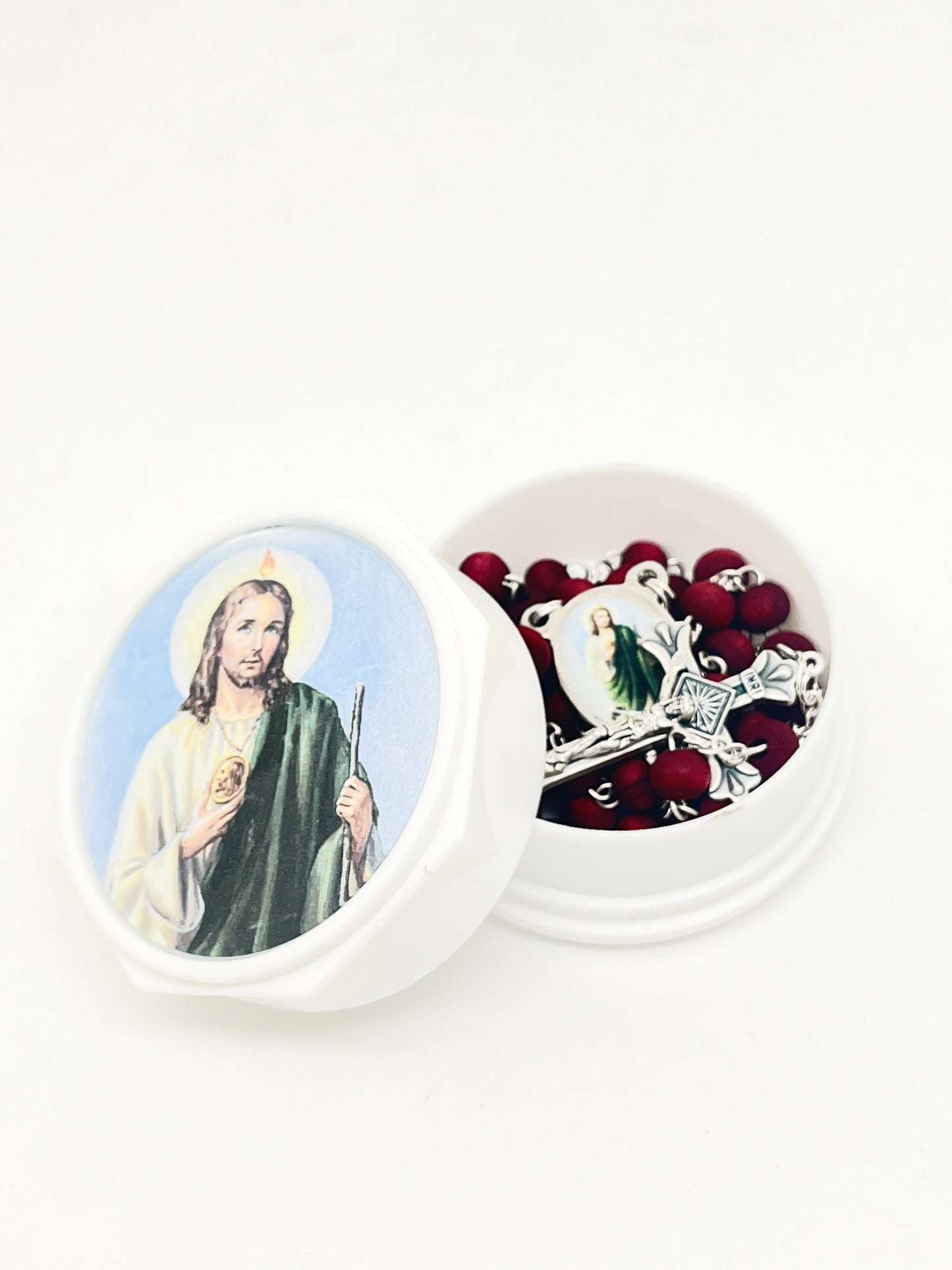 St. Jude rose scented rosary with red beads and silver crucifix in white round case featuring St. Jude image on lid.
