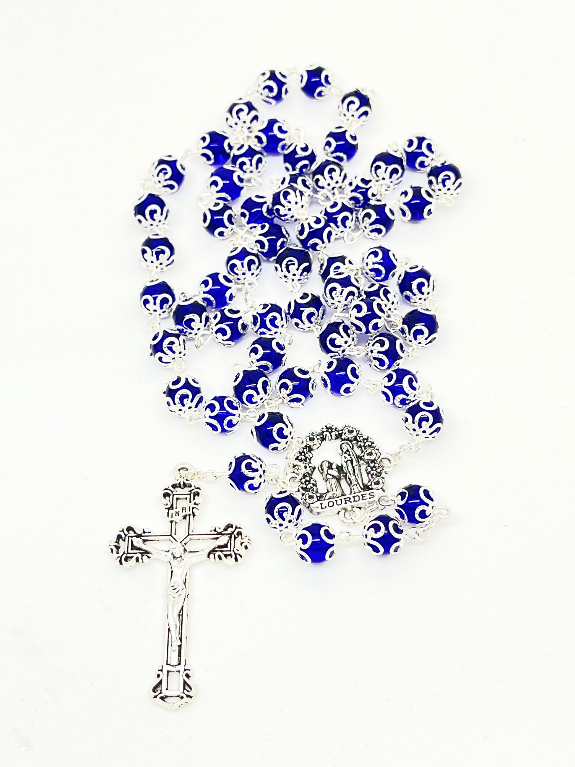 Lourdes Blue Glass rosary with silver crucifix and centerpiece depicting Bernadette praying to the Blessed Mother
