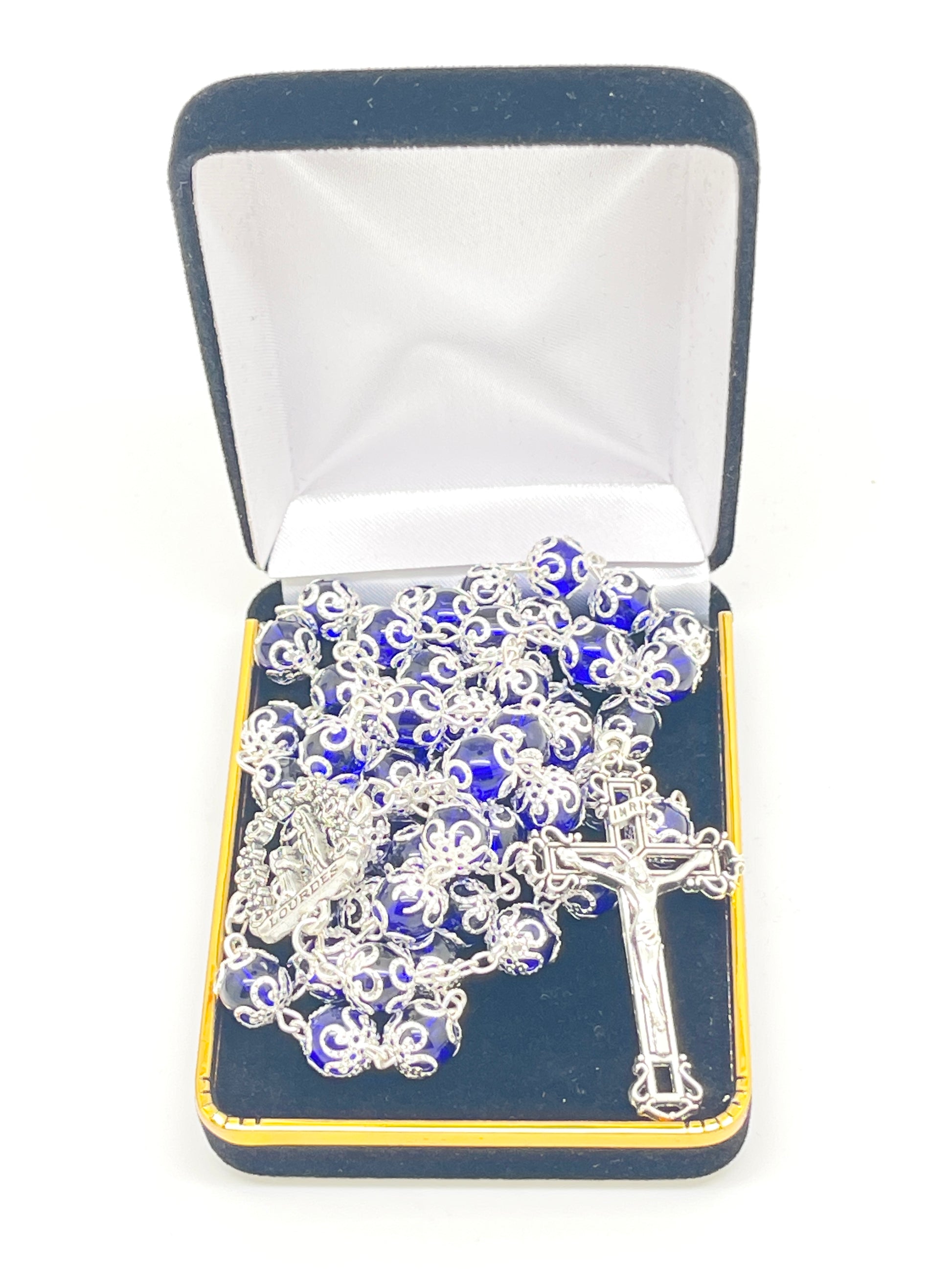 Lourdes blue glass rosary with silver centerpiece of Bernadette praying and matching ornate crucifix in velvet box