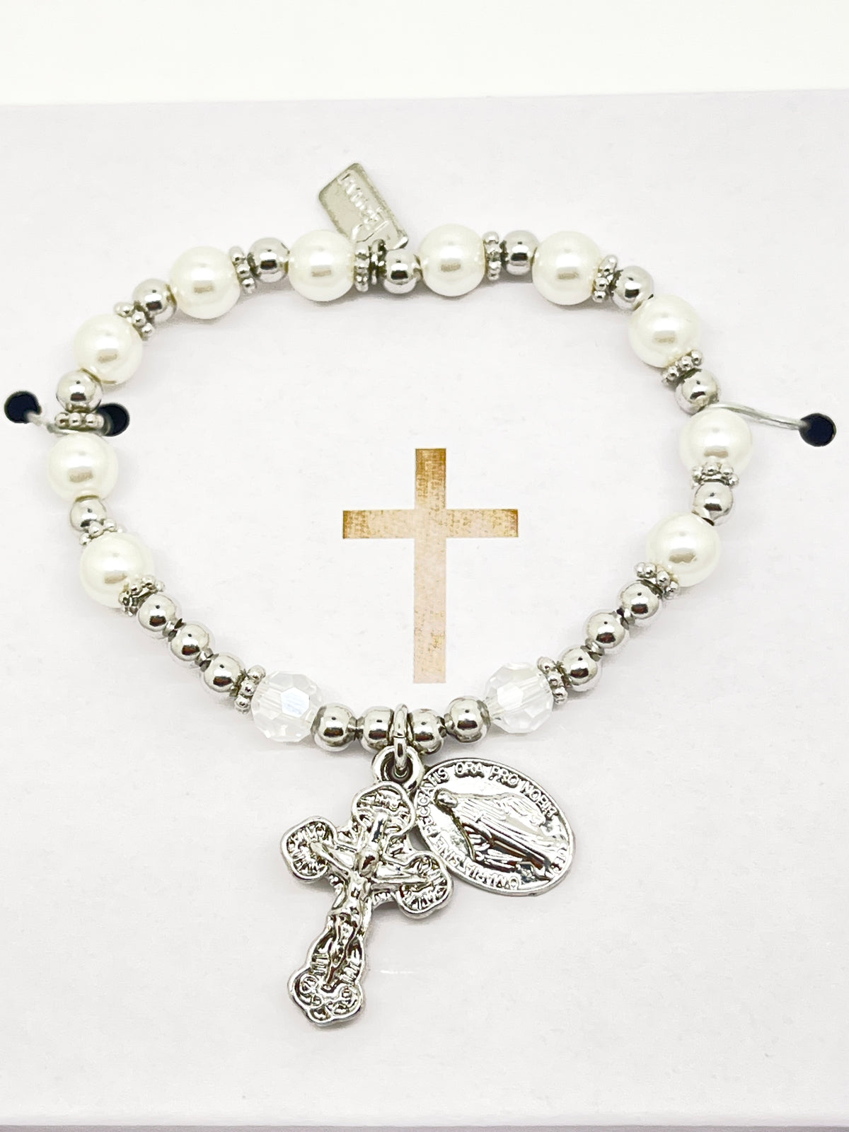 Silver and white glass pearl rosary bracelet with detailed silver crucifix and Miraculous Medal charm on elastic band