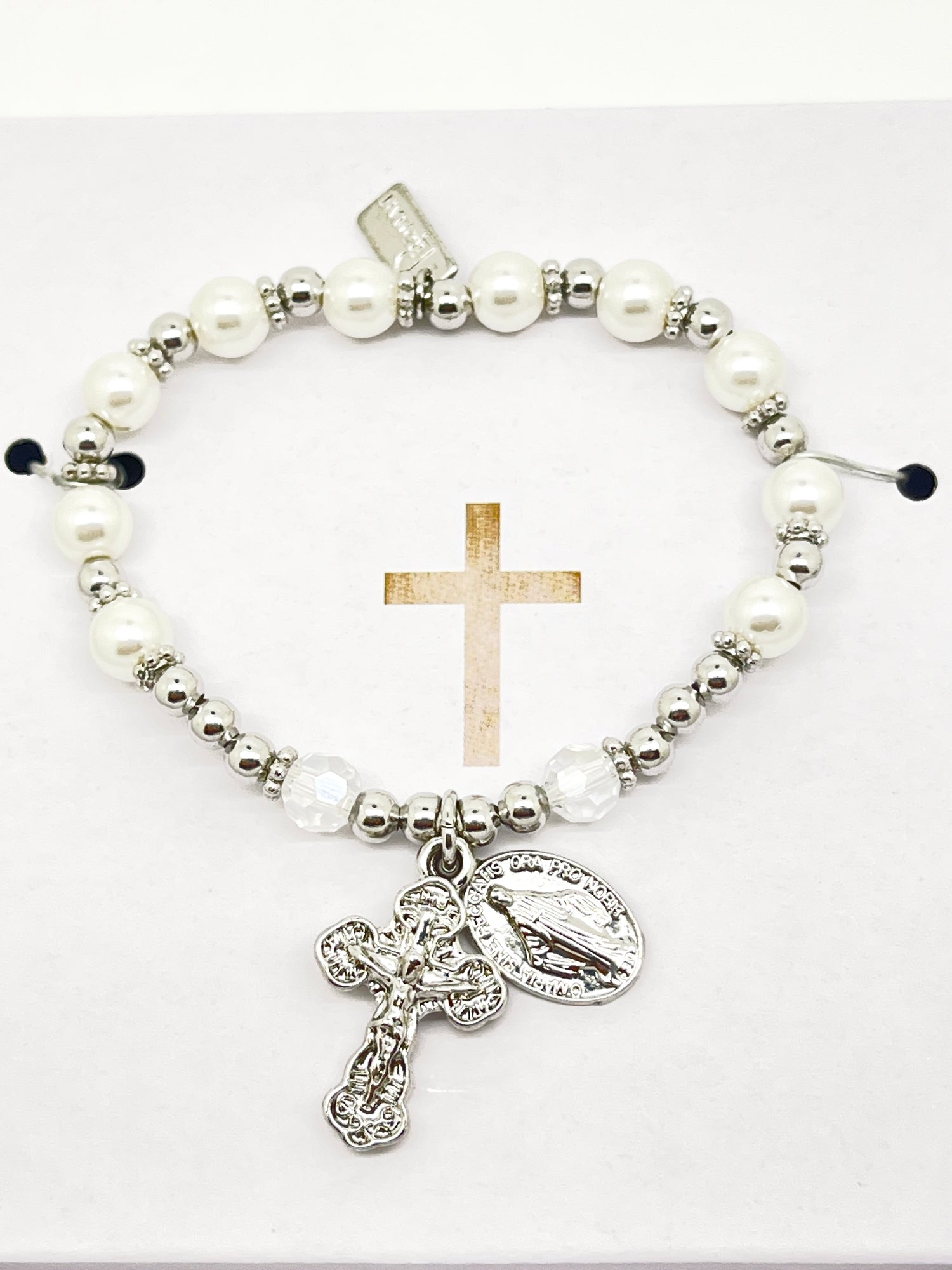 Silver and white glass pearl rosary bracelet with detailed silver crucifix and Miraculous Medal charm on elastic band