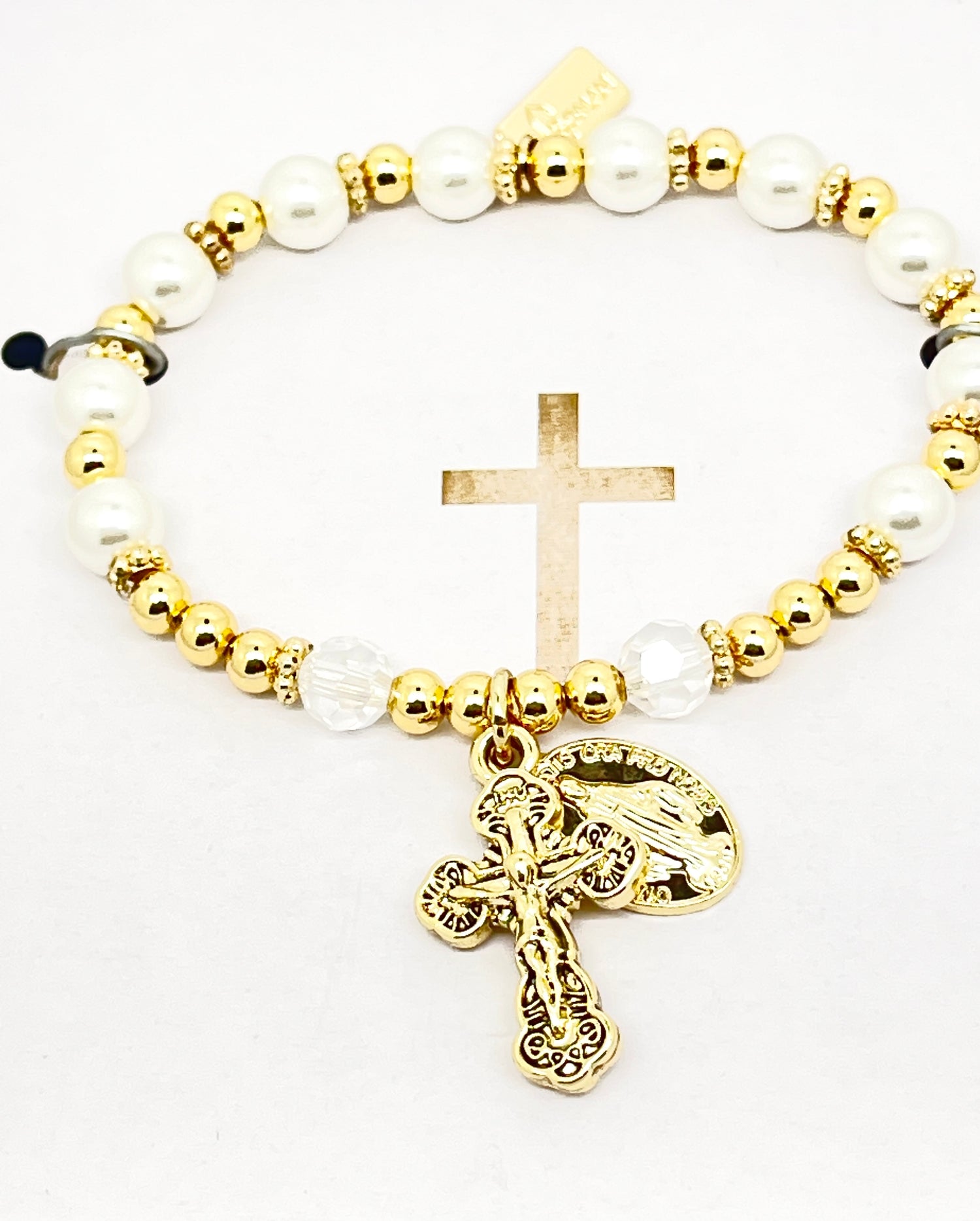Gold and white glass pearl rosary bracelet with clear glass beads and detailed gold Miraculous Medal charm.