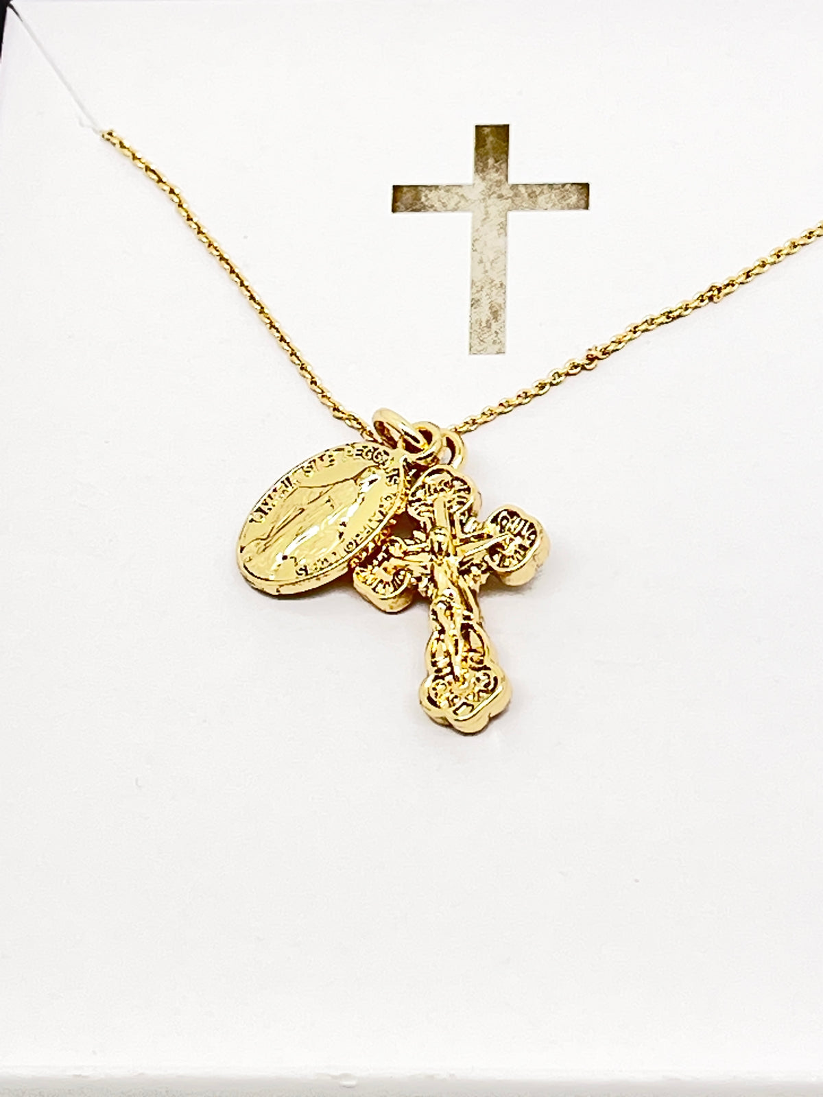 Gold Miraculous Medal and ornate crucifix necklace on delicate chain, 15 inches long, symbolizing faith and devotion.