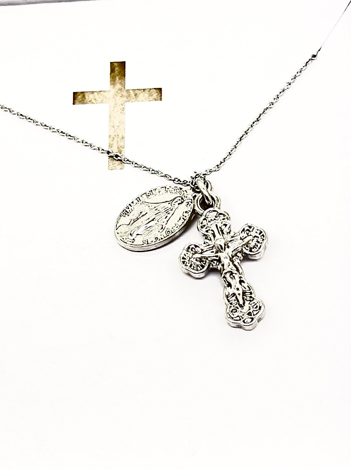 Silver necklace with detailed Miraculous Medal and ornate crucifix pendant, 15 inches long, symbolizing faith and protection