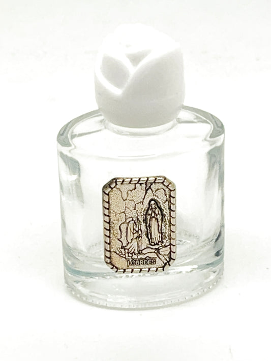 Clear glass holy water bottle 2.25 inches tall with Our Lady of Lourdes silver-tone emblem and white rose cap.