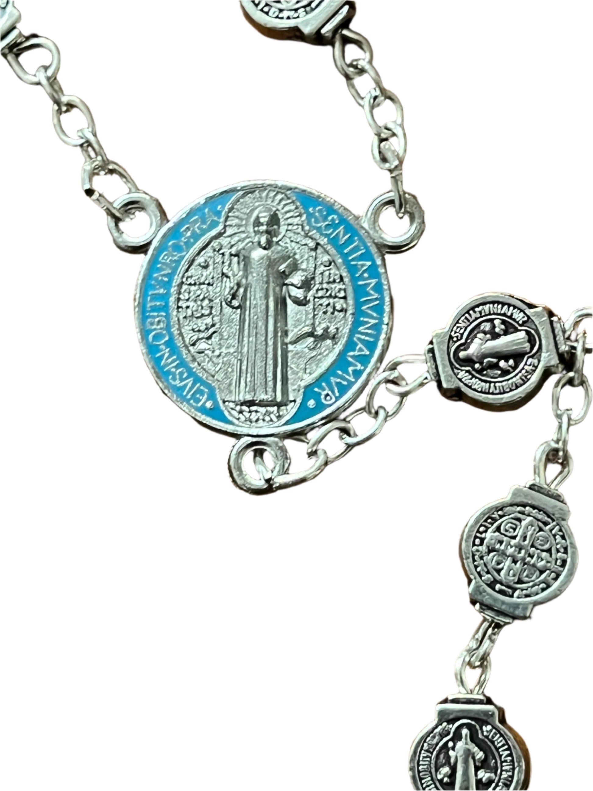 Silver St. Benedict Rosary centerpiece with color-splashed blue enamel, silver medals, and detailed chain links close-up view