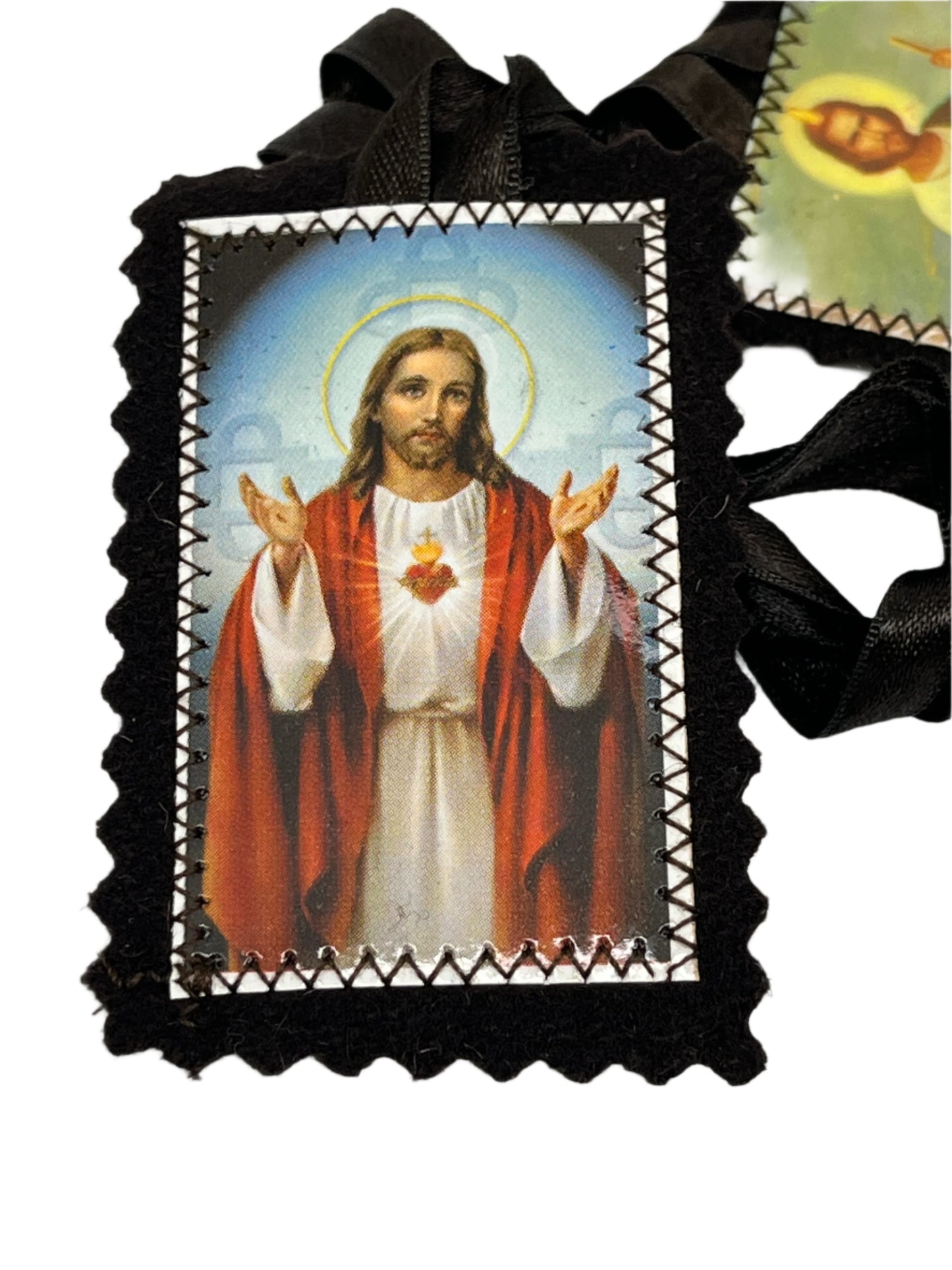 Brown scapular featuring Sacred Heart of Jesus image with black ribbon and stitched border, 3 inches long