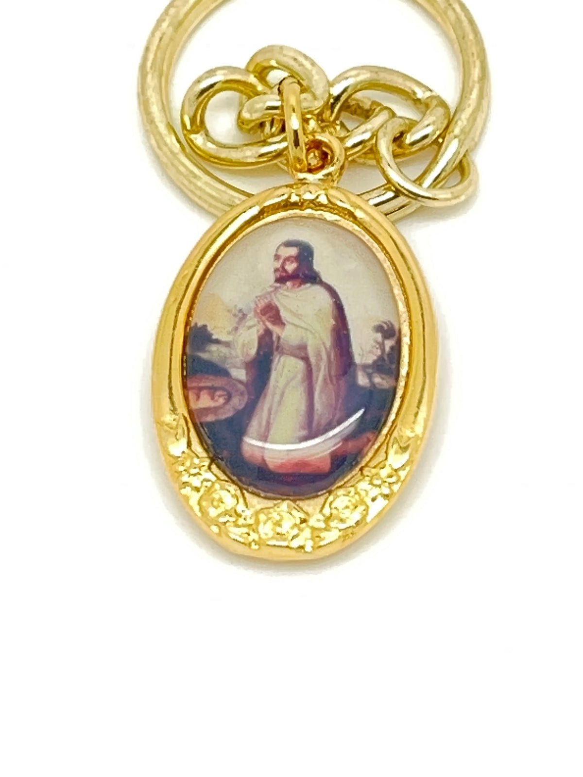 Gold key chain with oval image of St. Juan Diego in prayer, featuring detailed floral border design