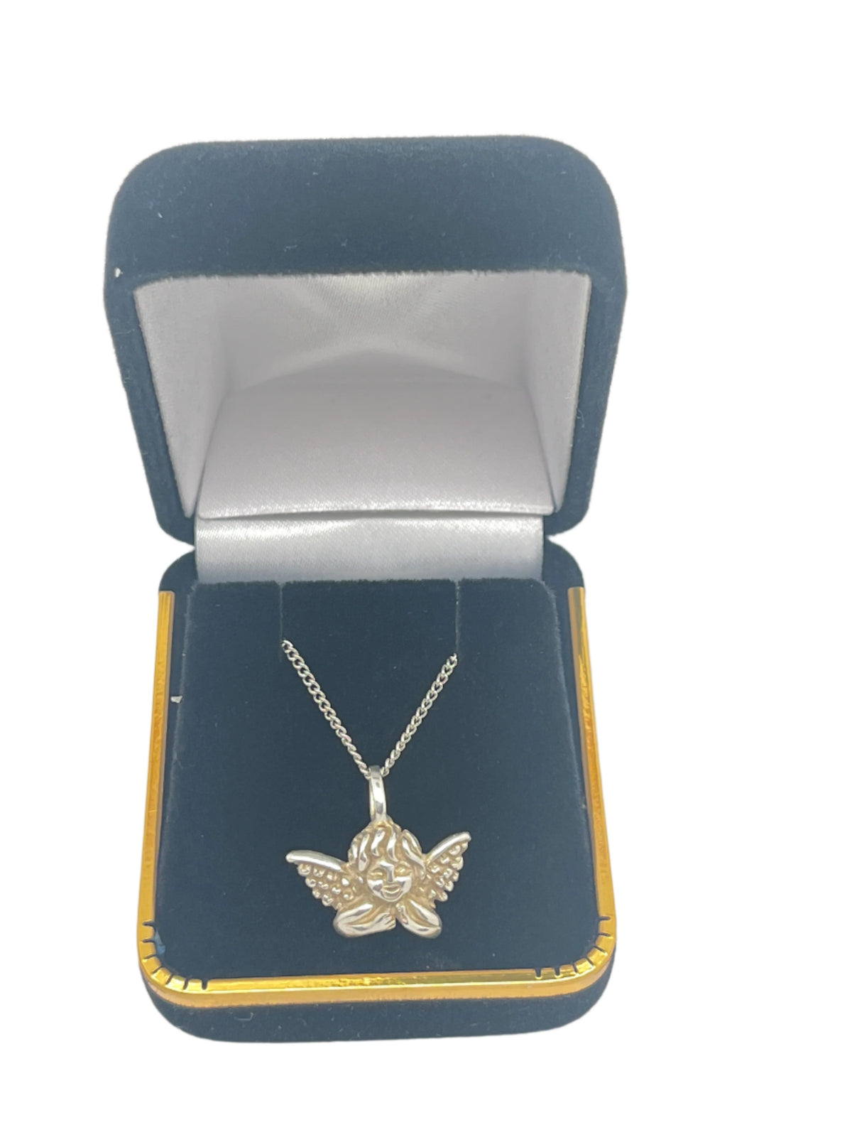 Handcrafted sterling silver Guardian Angel medal pendant with detailed wings, displayed inside a black velvet gift box.