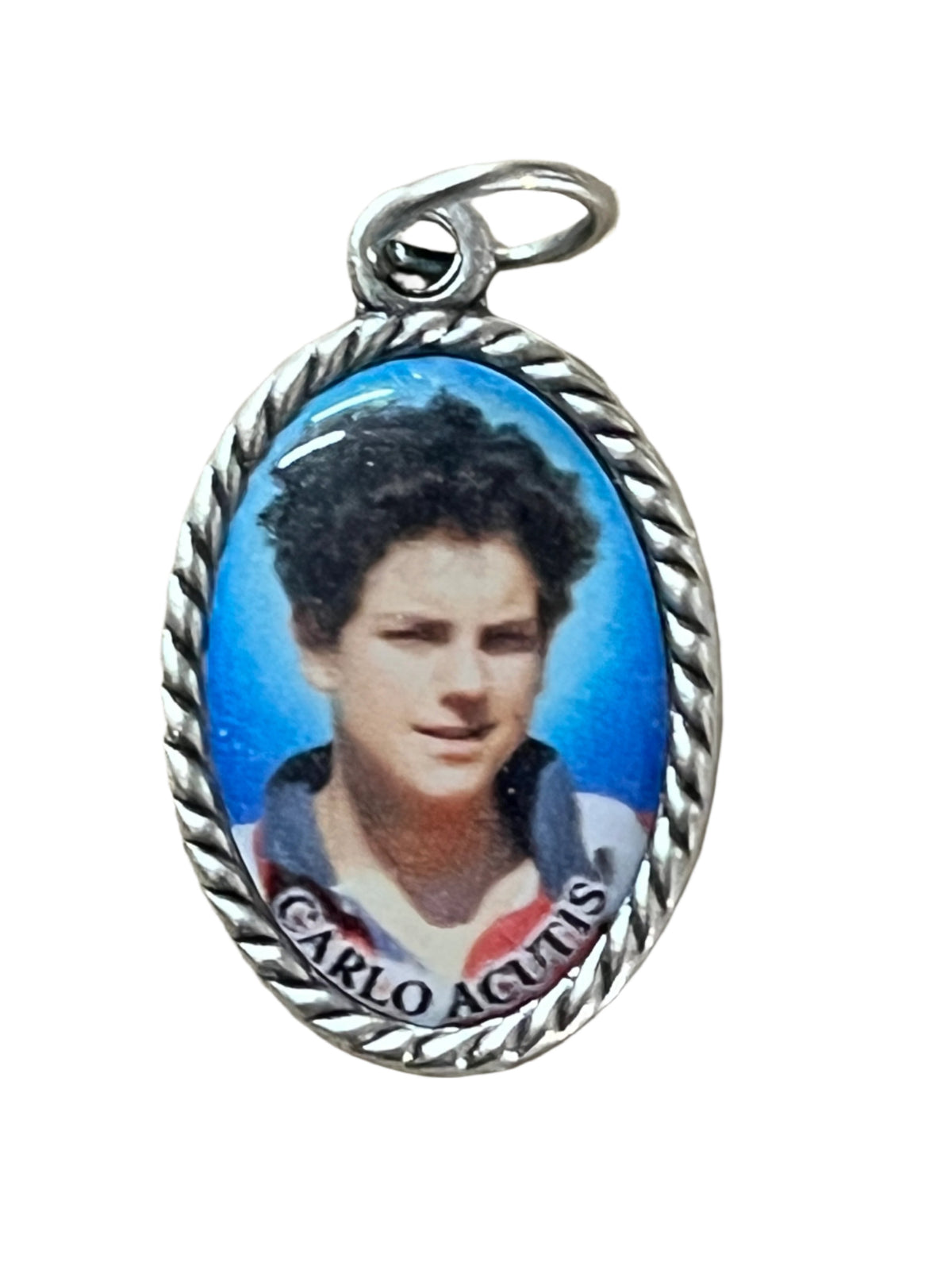 3/4" oval Carlo Acutis medal with detailed portrait, silver twisted-edge frame, and vibrant blue background