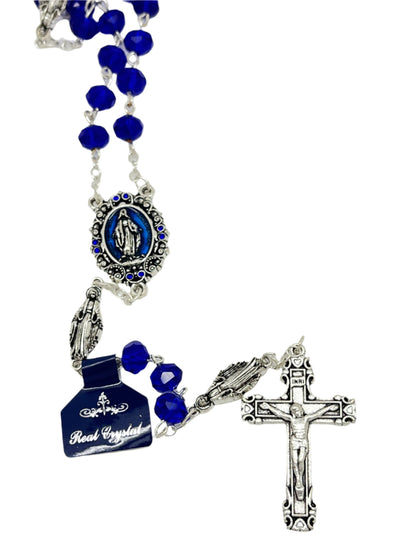 Blue crystal Miraculous Medal rosary with silver Our Lady of Grace beads and silver-toned crucifix on white background