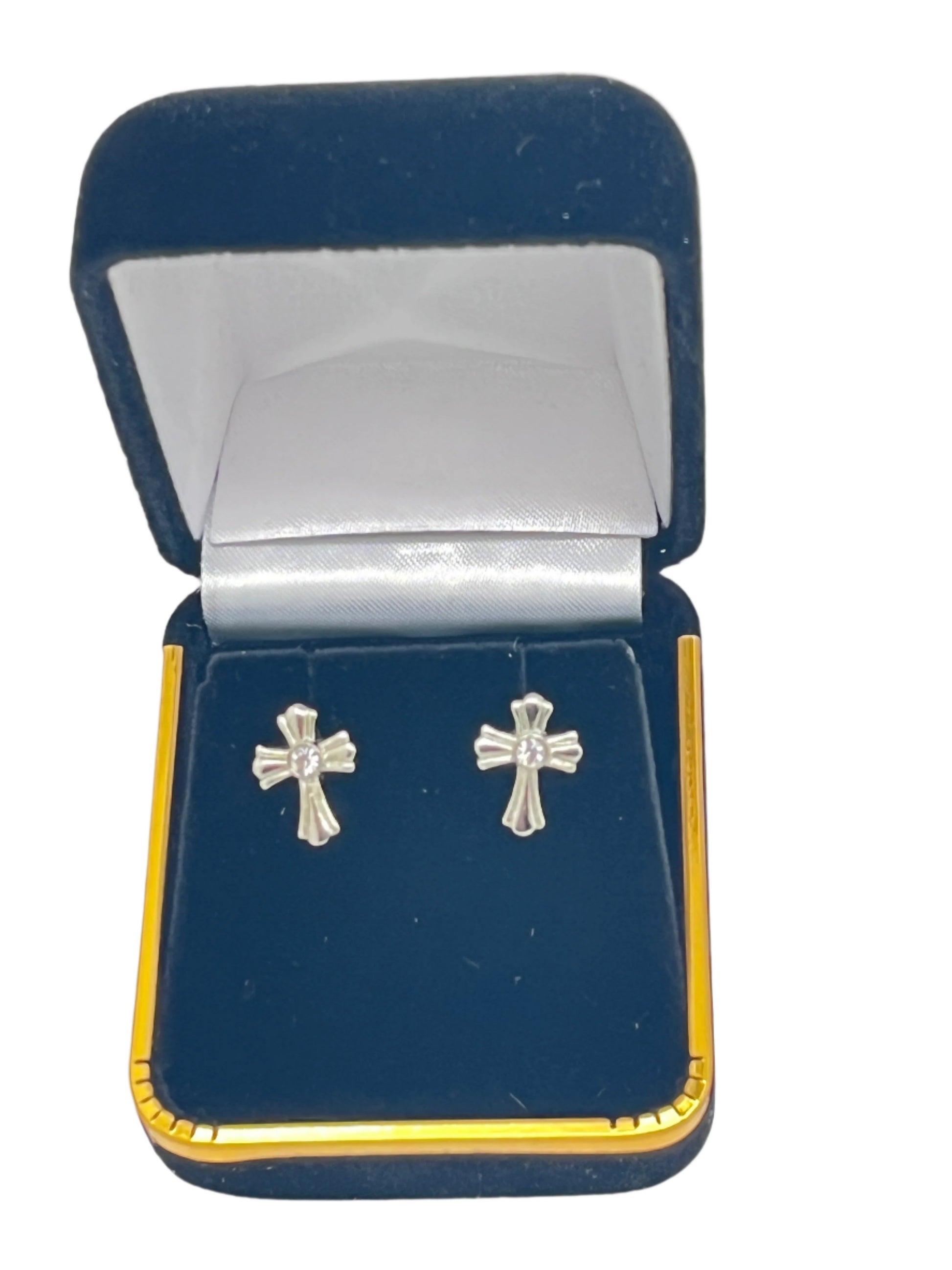Petite crystal cross stud earrings in surgical steel, displayed in a navy blue velvet jewelry box with gold trim.