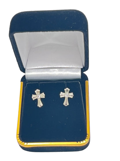 Petite crystal cross stud earrings in surgical steel, displayed in a navy blue velvet jewelry box with gold trim.