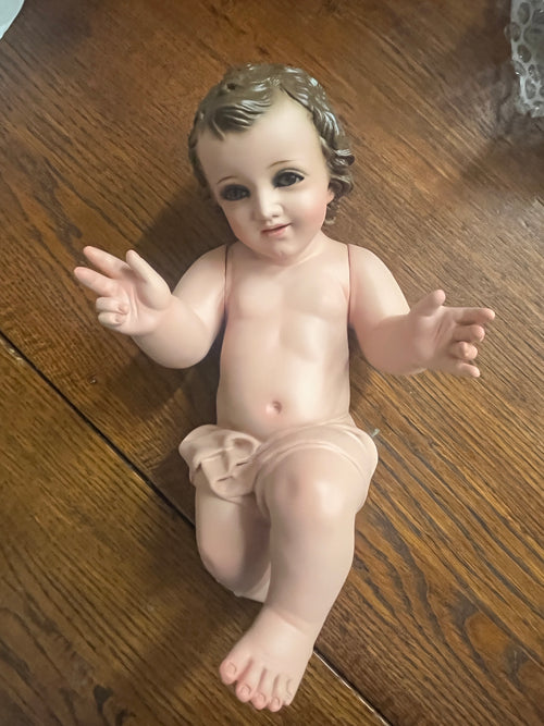 Hand-painted 8-inch Baby Jesus figurine with movable arms, glass eyes, and intricate details by Mexican artisans.