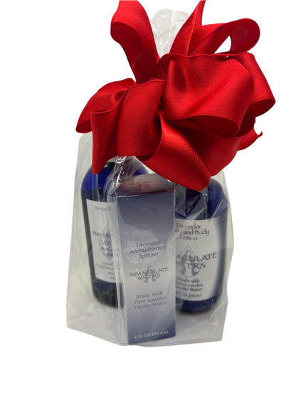 Immaculate Waters Lavender Kit with hand and body lotion, liquid soap, and aromatherapy spritzer in clear bag with red bow