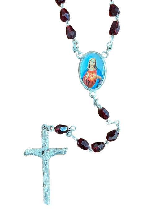 Sacred Heart of Jesus rosary with red crystal beads, silver-tone crucifix, and devotional centerpiece medal.