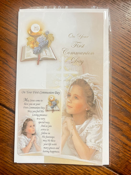First Communion card for a girl with a holy card featuring blessings and religious imagery on a beige background.