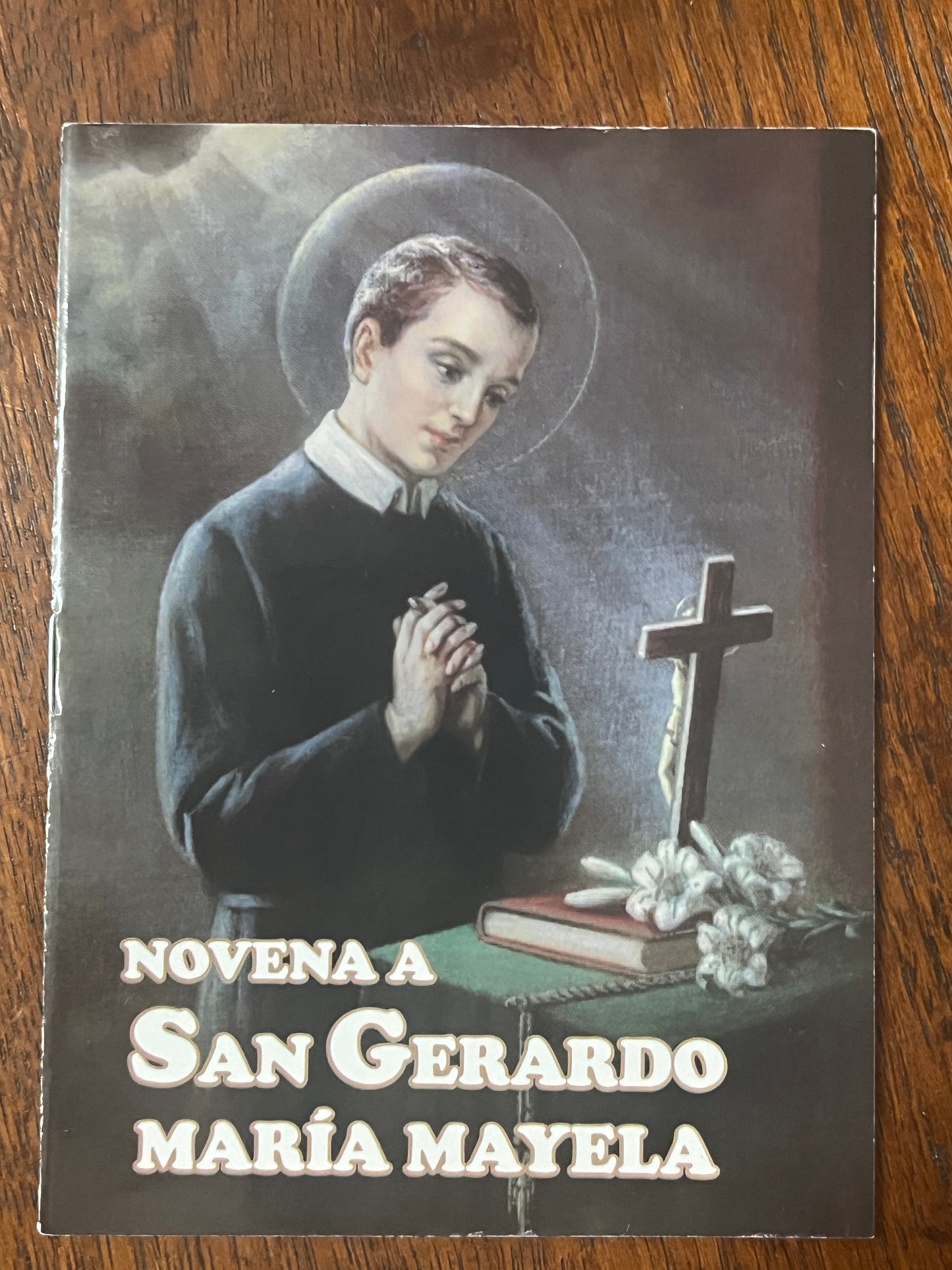 Novena to San Gerardo Maria Mayela prayer booklet with illustration of saint praying by a crucifix and flowers