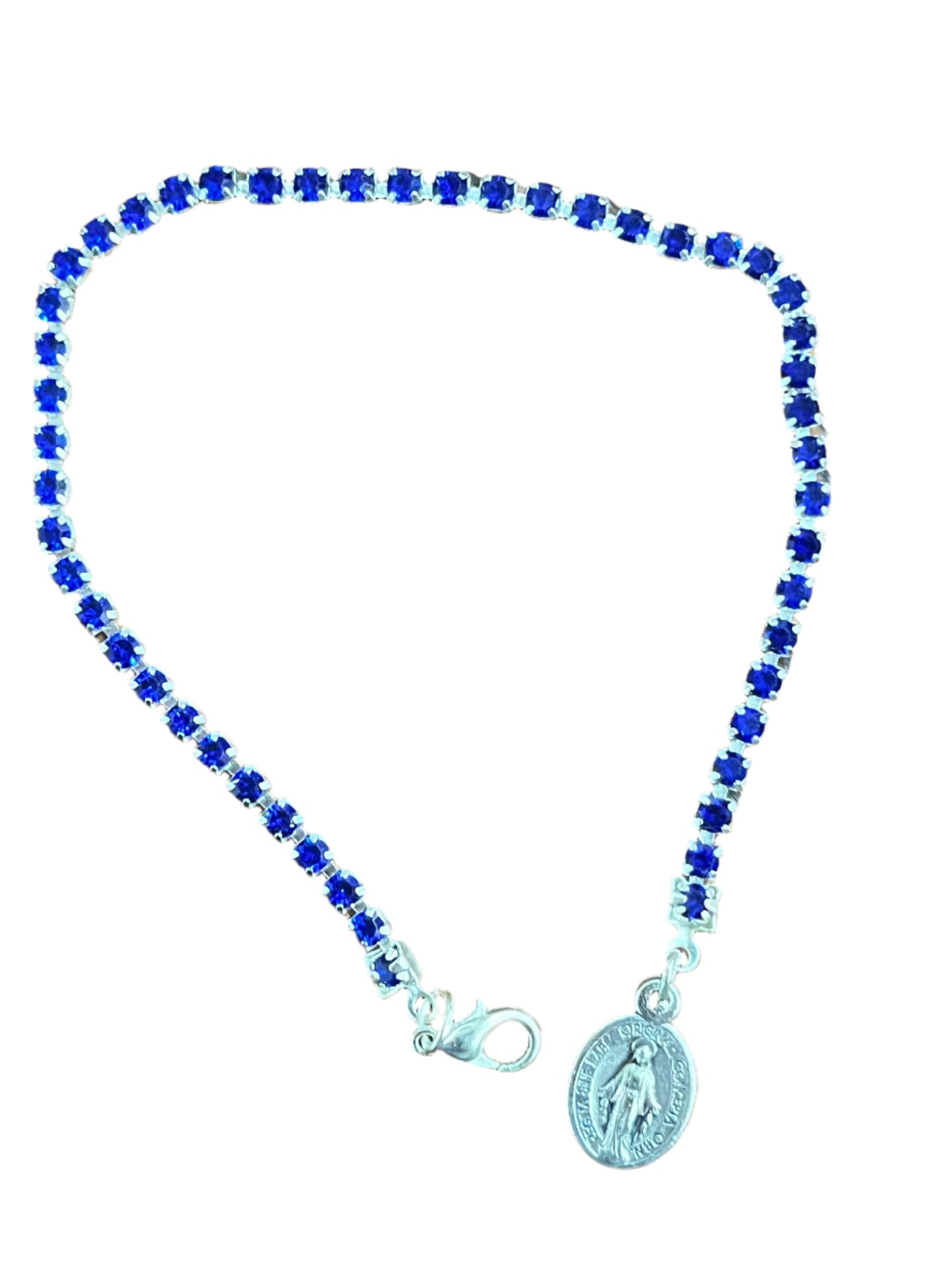 Blue crystal tennis bracelet with silver chain, Miraculous medal charm, and secure lobster claw clasp detail