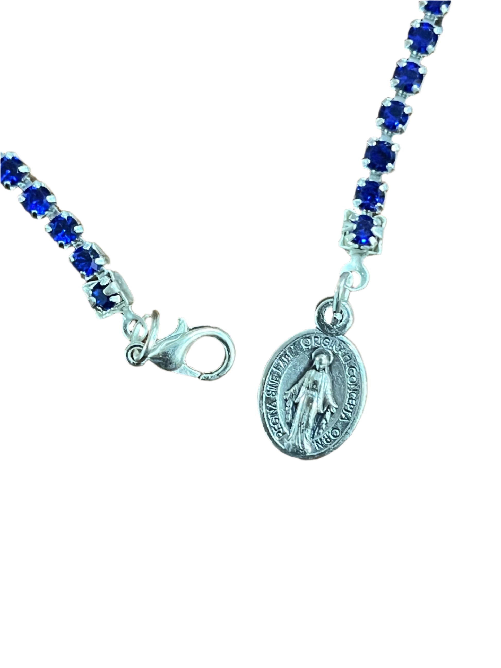 Blue crystal tennis bracelet with silver Miraculous medal charm and lobster claw clasp on delicate chain