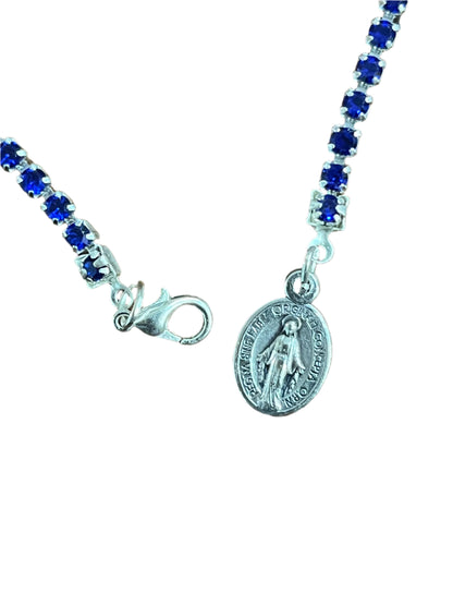 Blue crystal tennis bracelet with silver Miraculous medal charm and lobster claw clasp on delicate chain