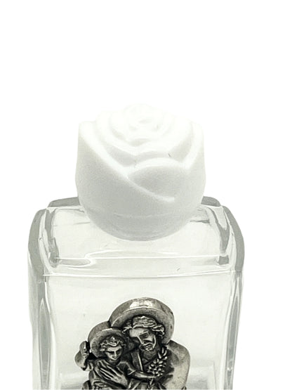 Small clear glass holy water bottle with pewter St. Joseph image and white rose-shaped cap
