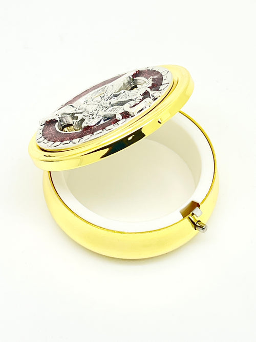 2 1/8" gold pyx with pewter St. Michael medallion, red enamel accents, and white plastic lining inside