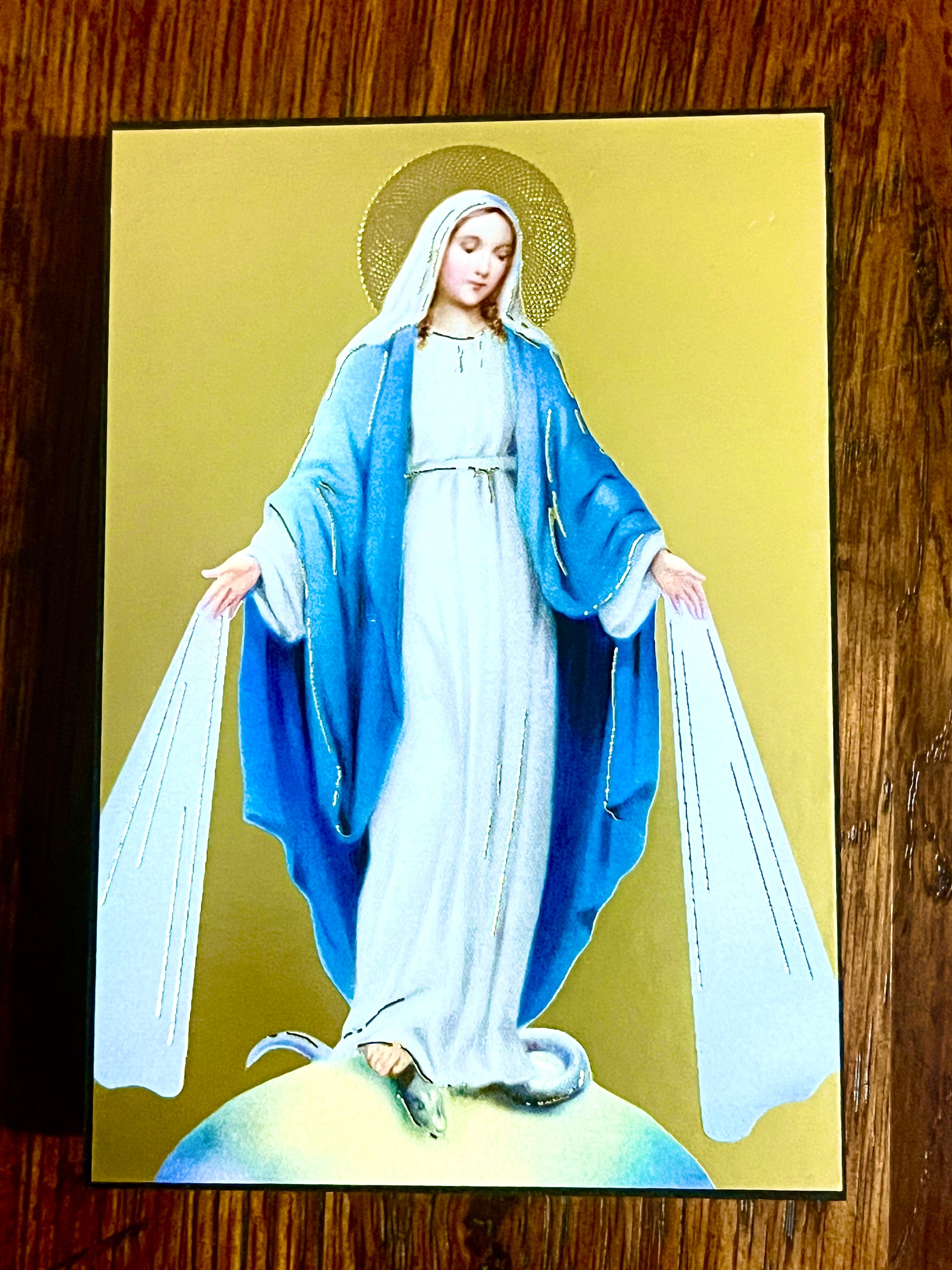 3 3/4" Our Lady of Grace standing plaque with blue and white robes, gold halo, and serpent underfoot on gold background