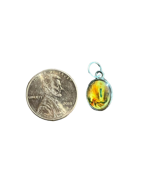 Small oval Our Lady of Lourdes medal charm with colorful image, size shown next to 2018 penny coin for scale