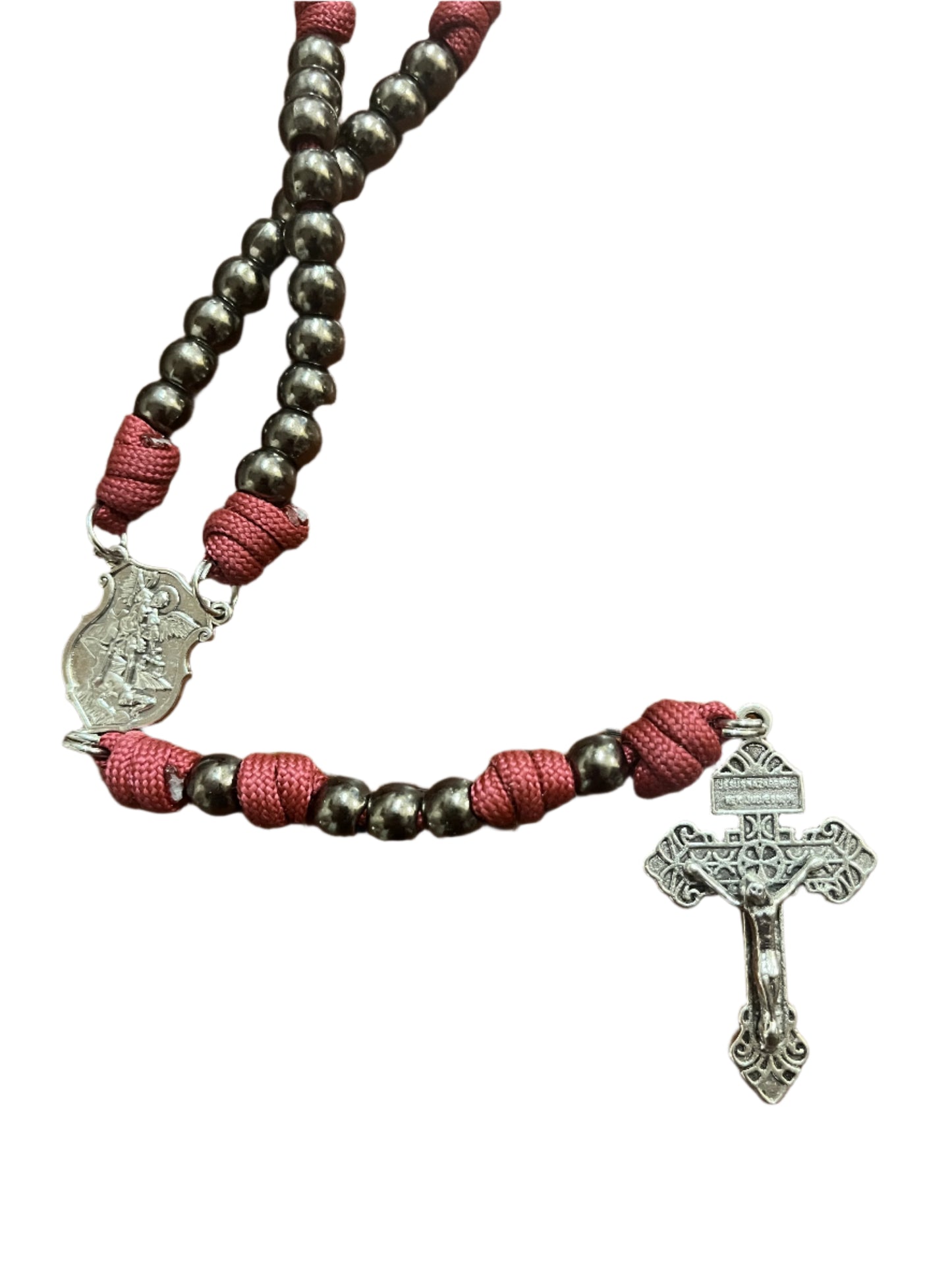 St. Michael paracord rosary with silver crucifix, dark beads, and red knotted cord for spiritual warfare protection.