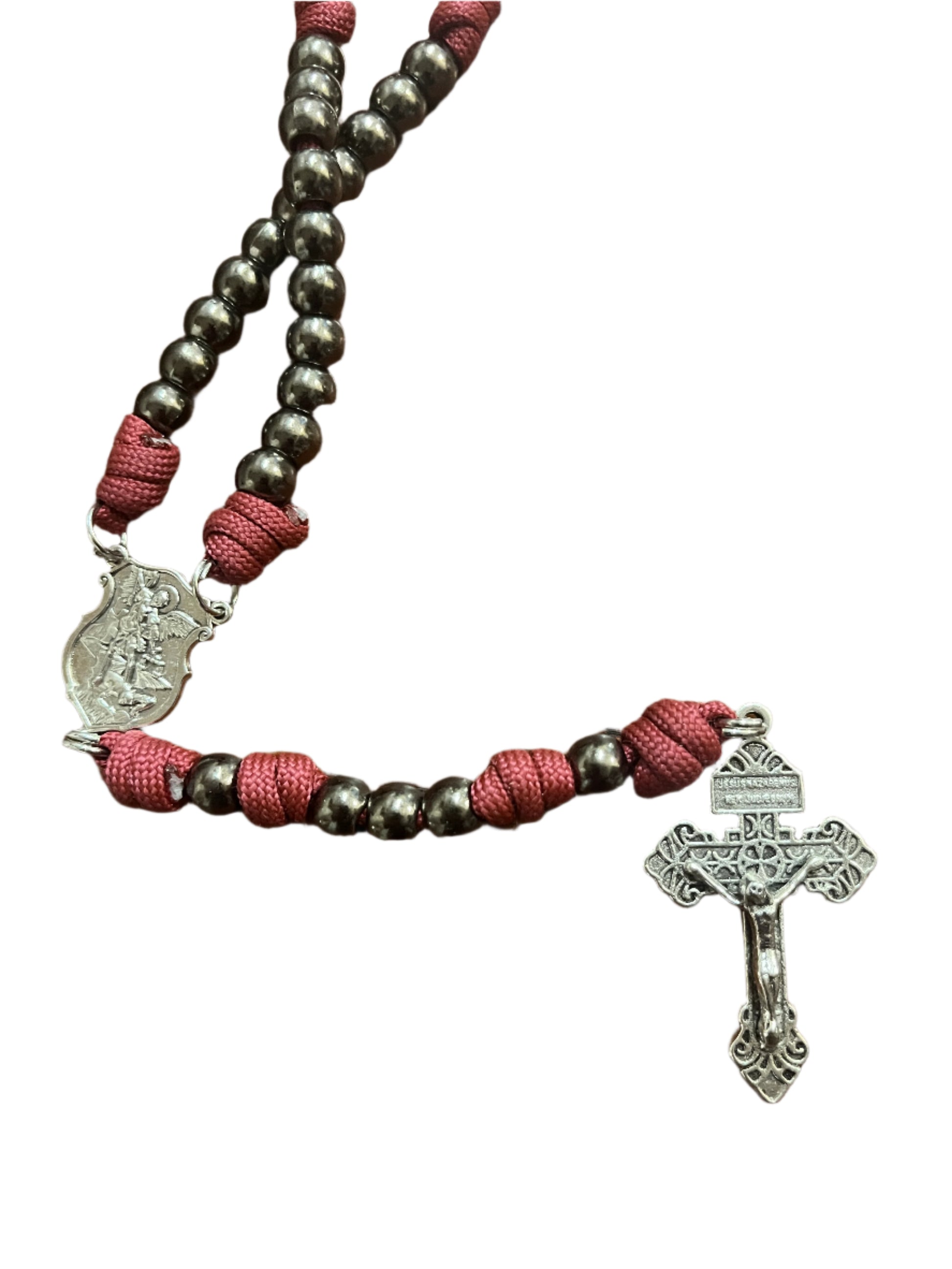 St. Michael paracord rosary with silver crucifix, dark beads, and red knotted cord for spiritual warfare protection.