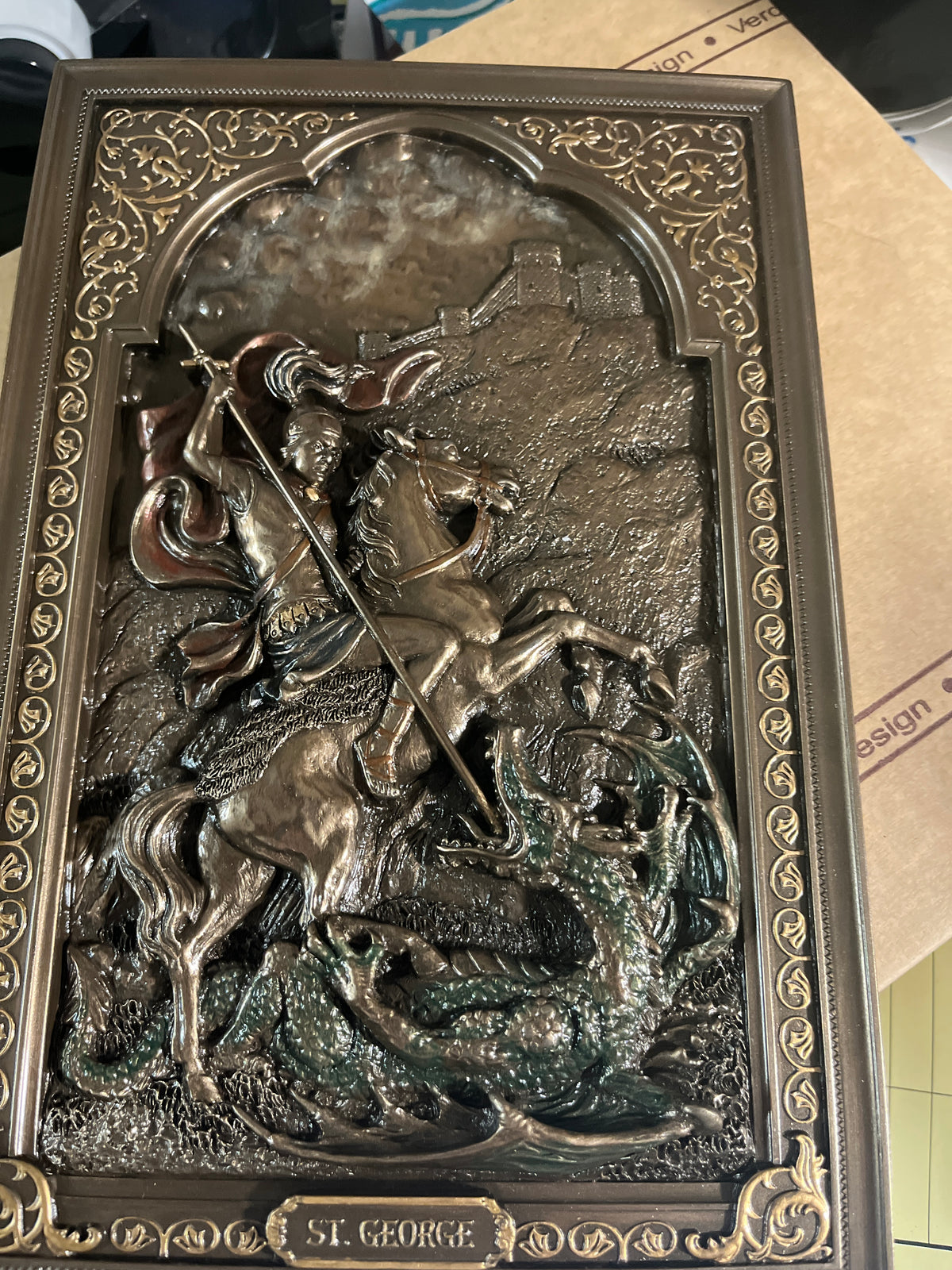 9" St. George wall plaque depicting Saint George slaying the dragon with detailed ornate border design