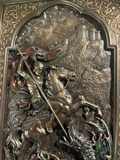 9" St. George wall plaque with detailed relief of saint on horseback slaying dragon and ornate border design