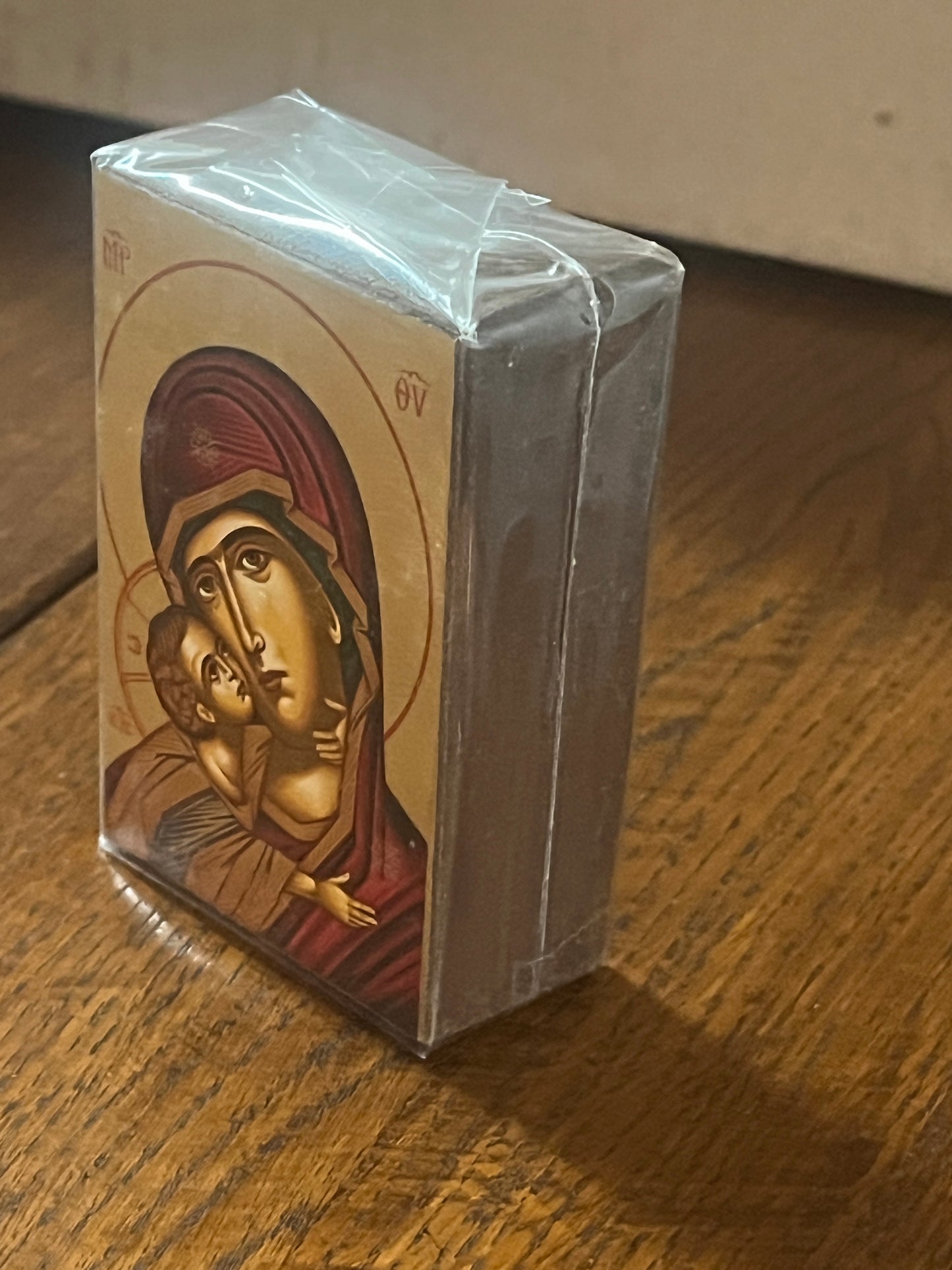 3 1/2" Greek hand painted Serigraph icon of the Red Madonna holding Child wrapped in protective plastic on wood surface