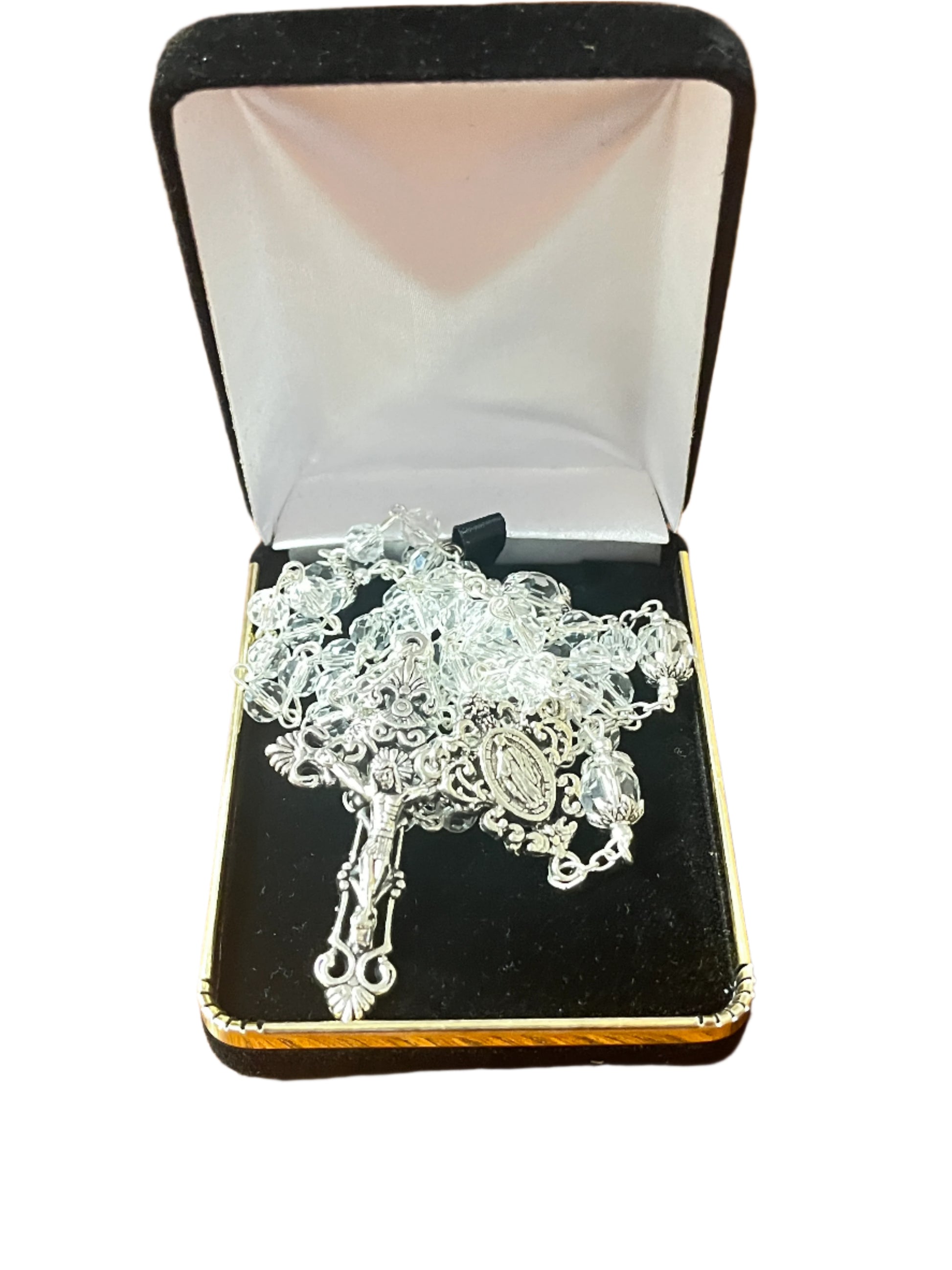 Clear crystal Our Lady of Grace rosary with silver crucifix and centerpiece, displayed in black velvet box