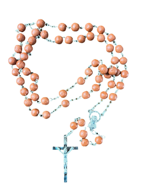 Rosary with natural rose petal beads and silver crucifix with Our Lady of Guadalupe centerpiece on white background