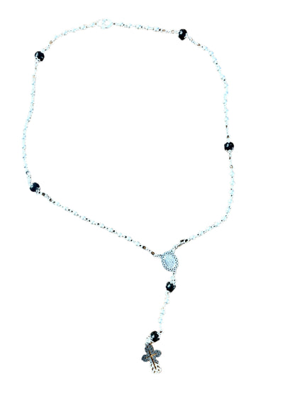 Silver and black 3mm rosary necklace with silver centerpiece and cross on white background