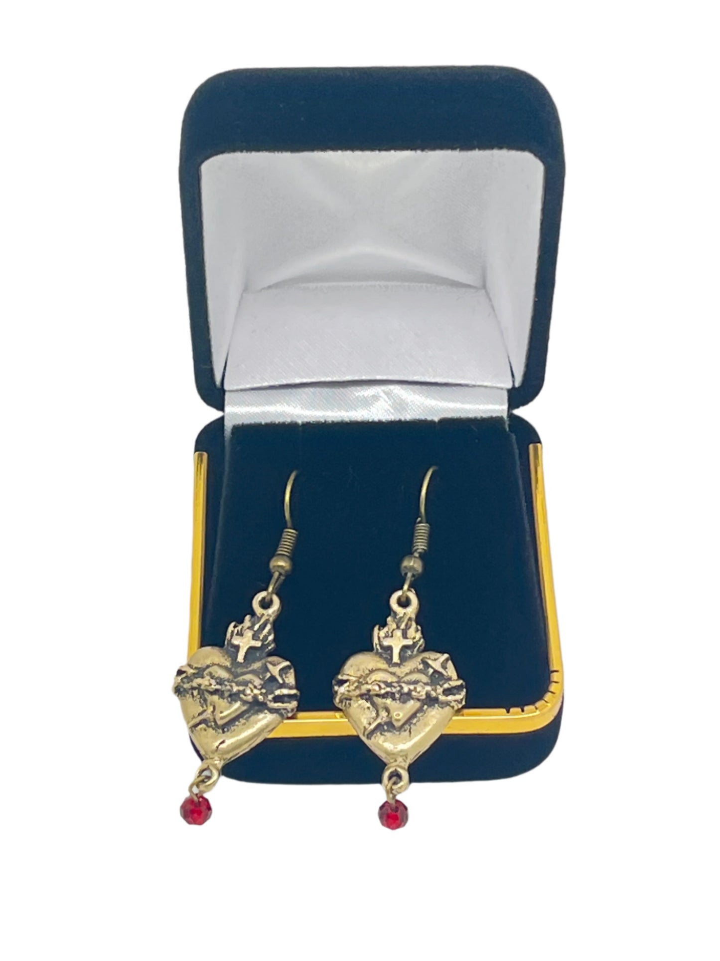 Sacred Hearts bronze earrings with red crystal drops displayed in blue velvet jewelry box with satin lining