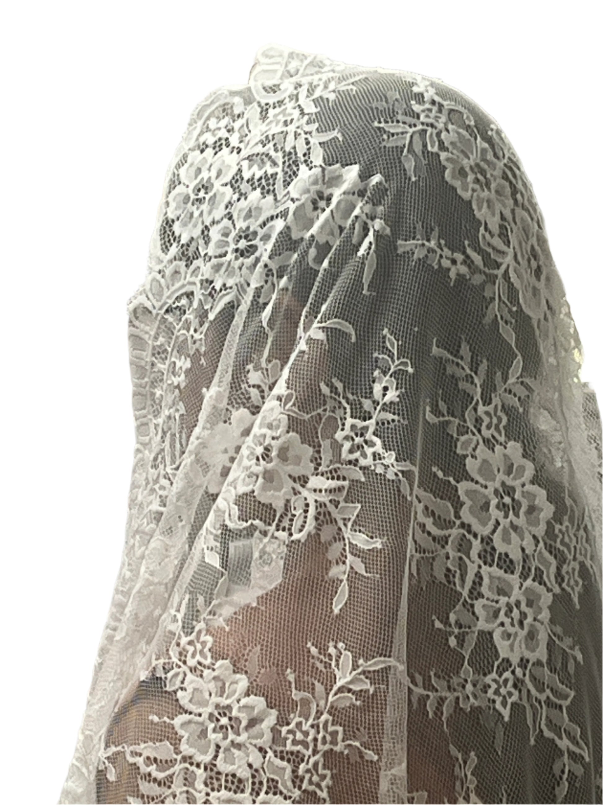 61" white Gabriela half circle lace mantilla veil with delicate floral motifs and scalloped edges over model's head