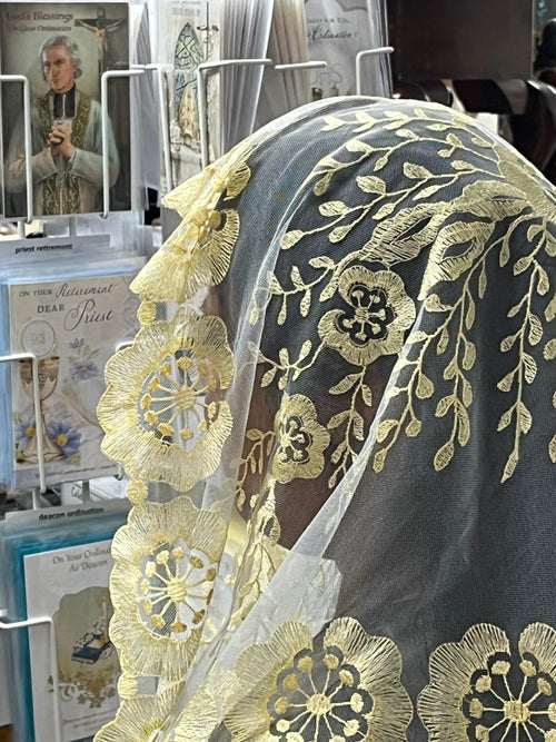 Pale yellow and white Spanish lace mantilla chapel veil with floral motifs and scalloped edges, 51 inches long.