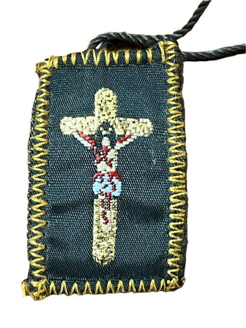 1 1/2" brown scapular with embroidered crucifix and gold-tone stitched border on black fabric background
