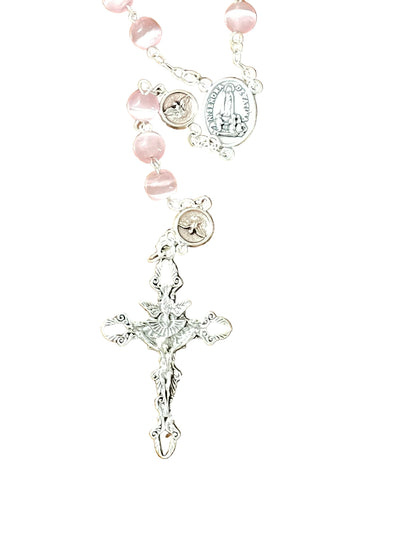 Close-up of Pink Tiger's Eye Holy Spirit Rosary with silver crucifix and detailed chain links on white background