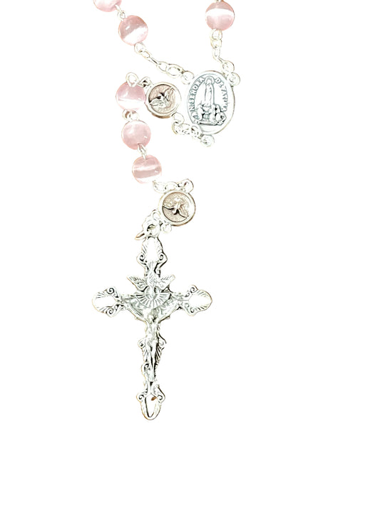 Close-up of Pink Tiger's Eye Holy Spirit Rosary with silver crucifix and detailed chain links on white background