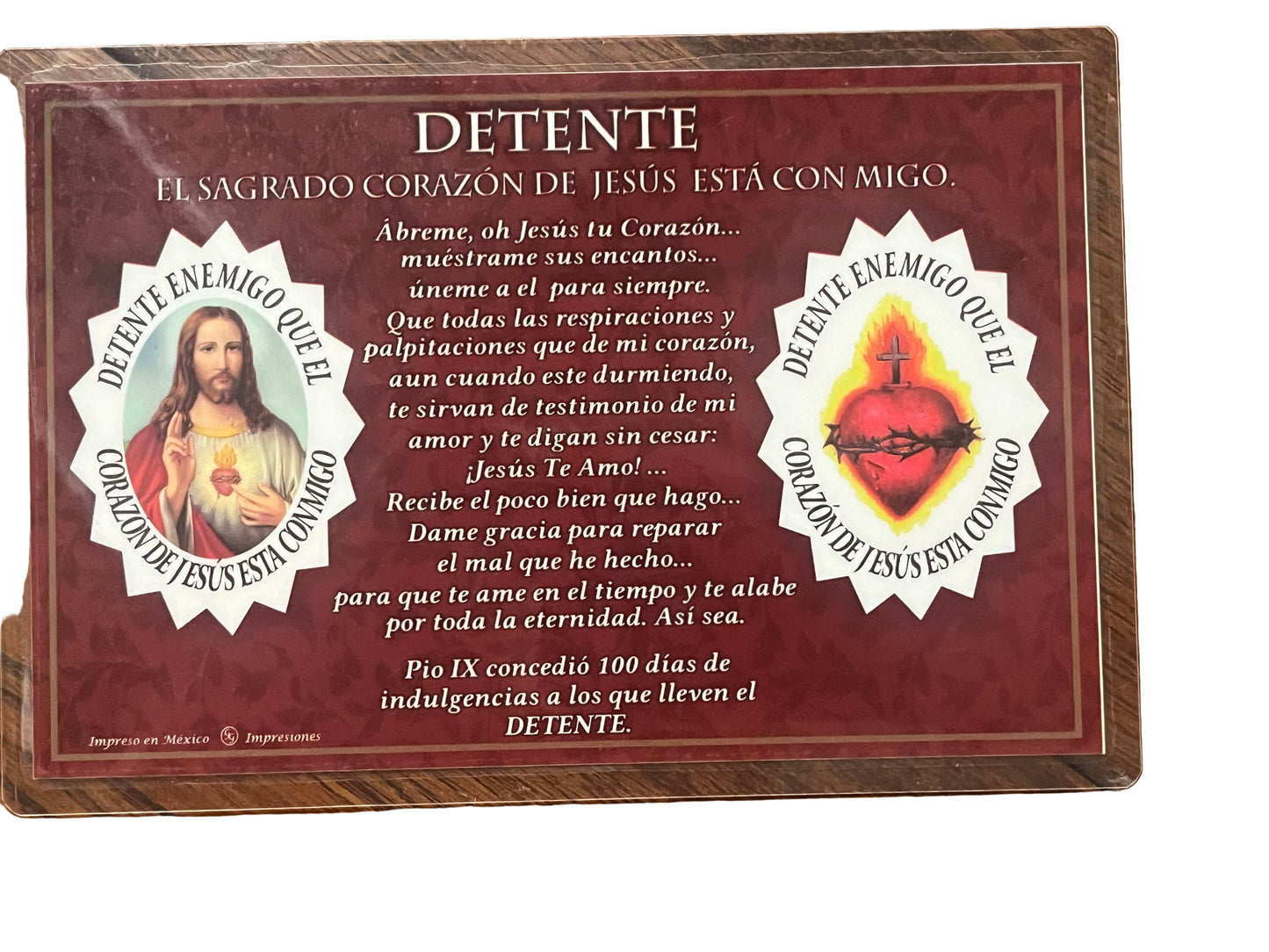 Home detente plaque with Sacred Heart of Jesus images and Spanish devotional prayer on rich red background