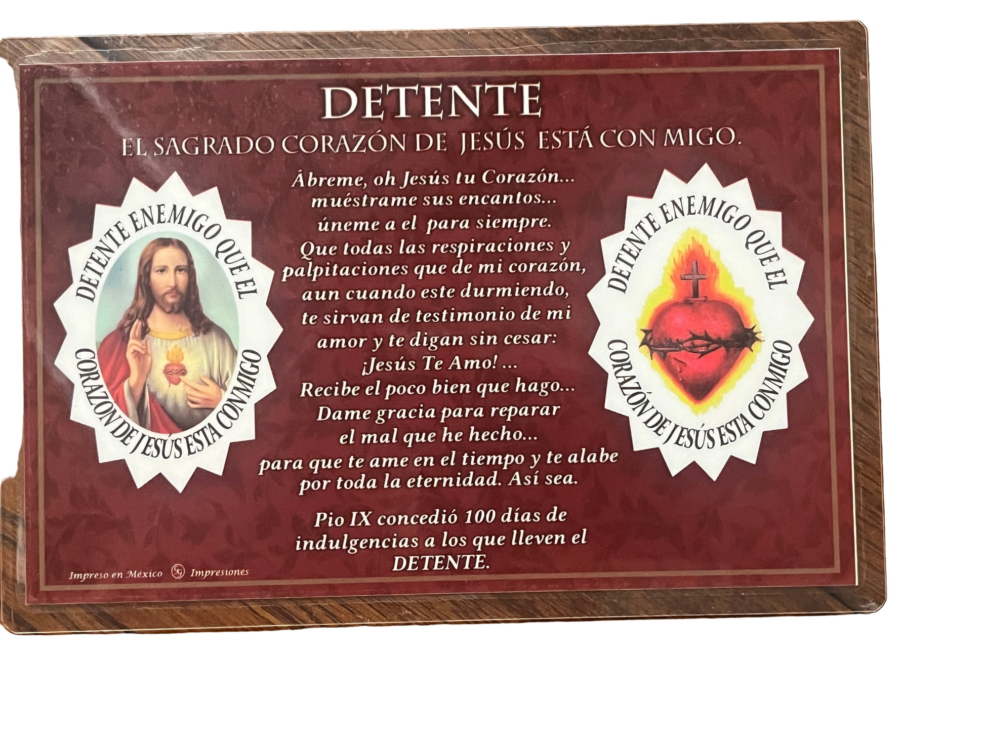 Home detente plaque with Sacred Heart of Jesus images and Spanish devotional prayer on rich red background